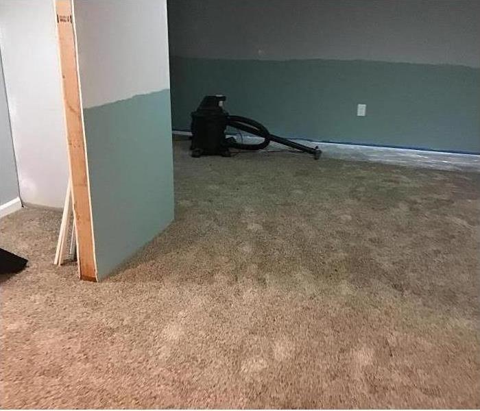 Storm Damaged Room with soaked carpet and walls