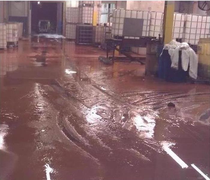 Storm Damage standing mud and water in warehouse 