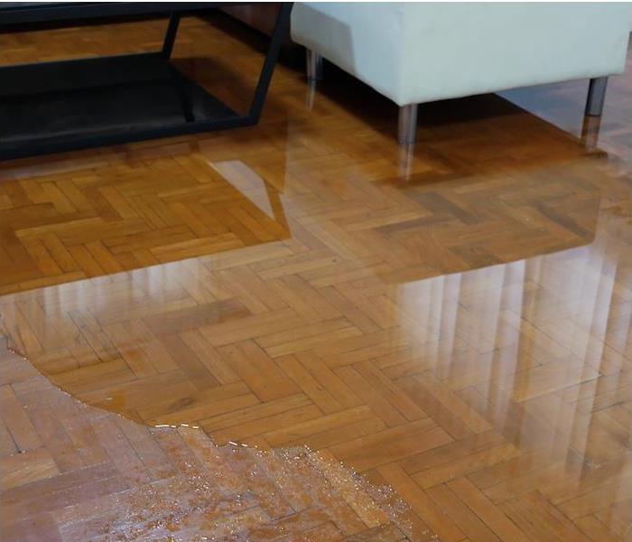 interior wood floor partially submerged in water 